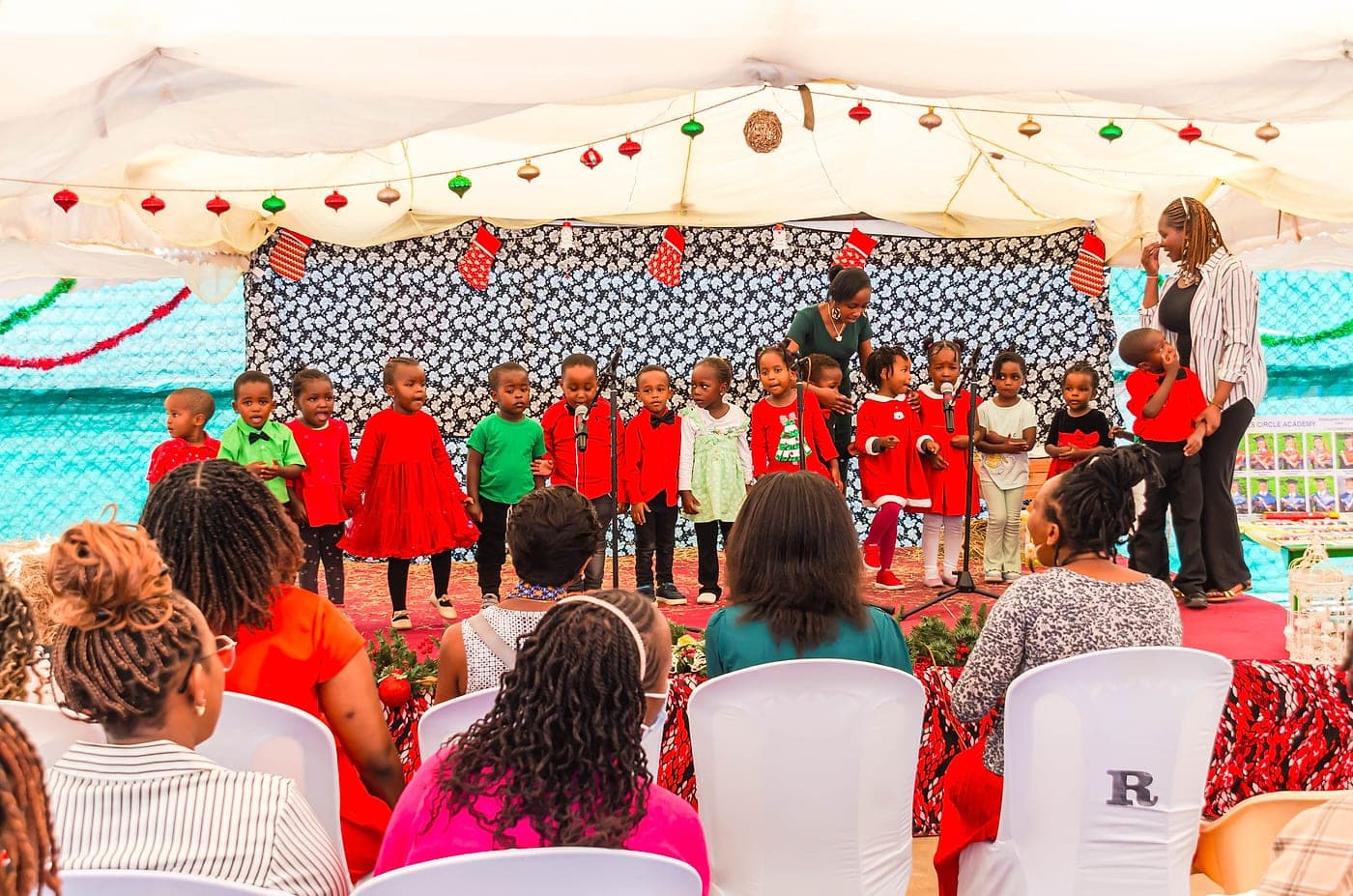 Parents seated watching their children perform at a school concert