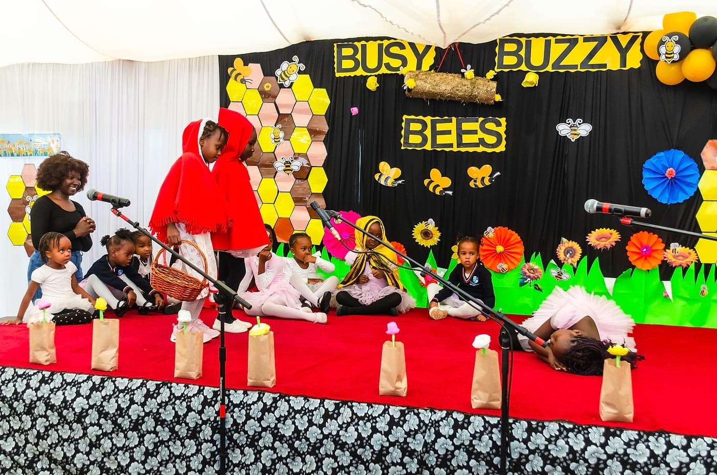 Learners in costume performing a story on stage
