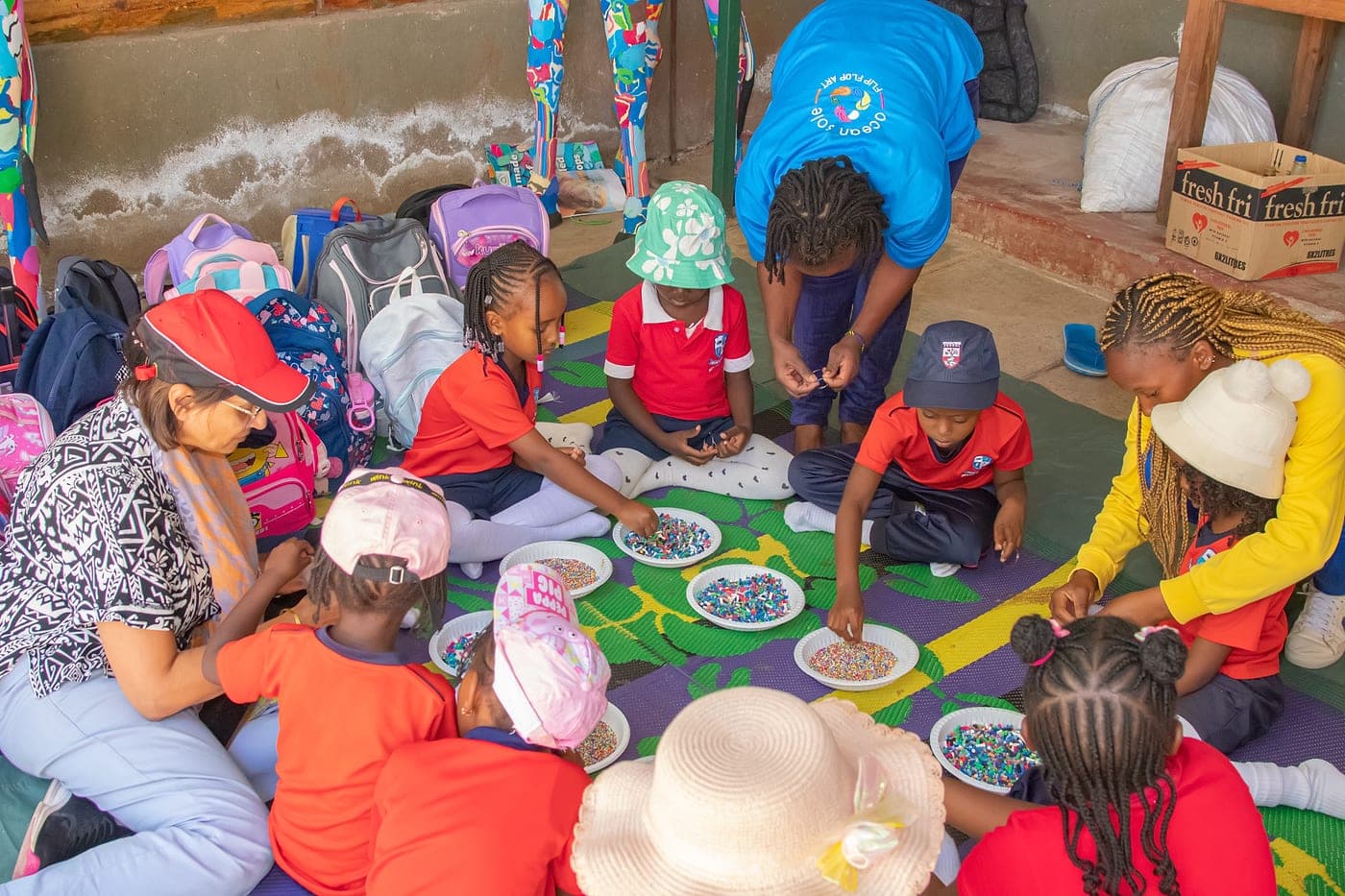 Children sorting recycled materials together in a workshop