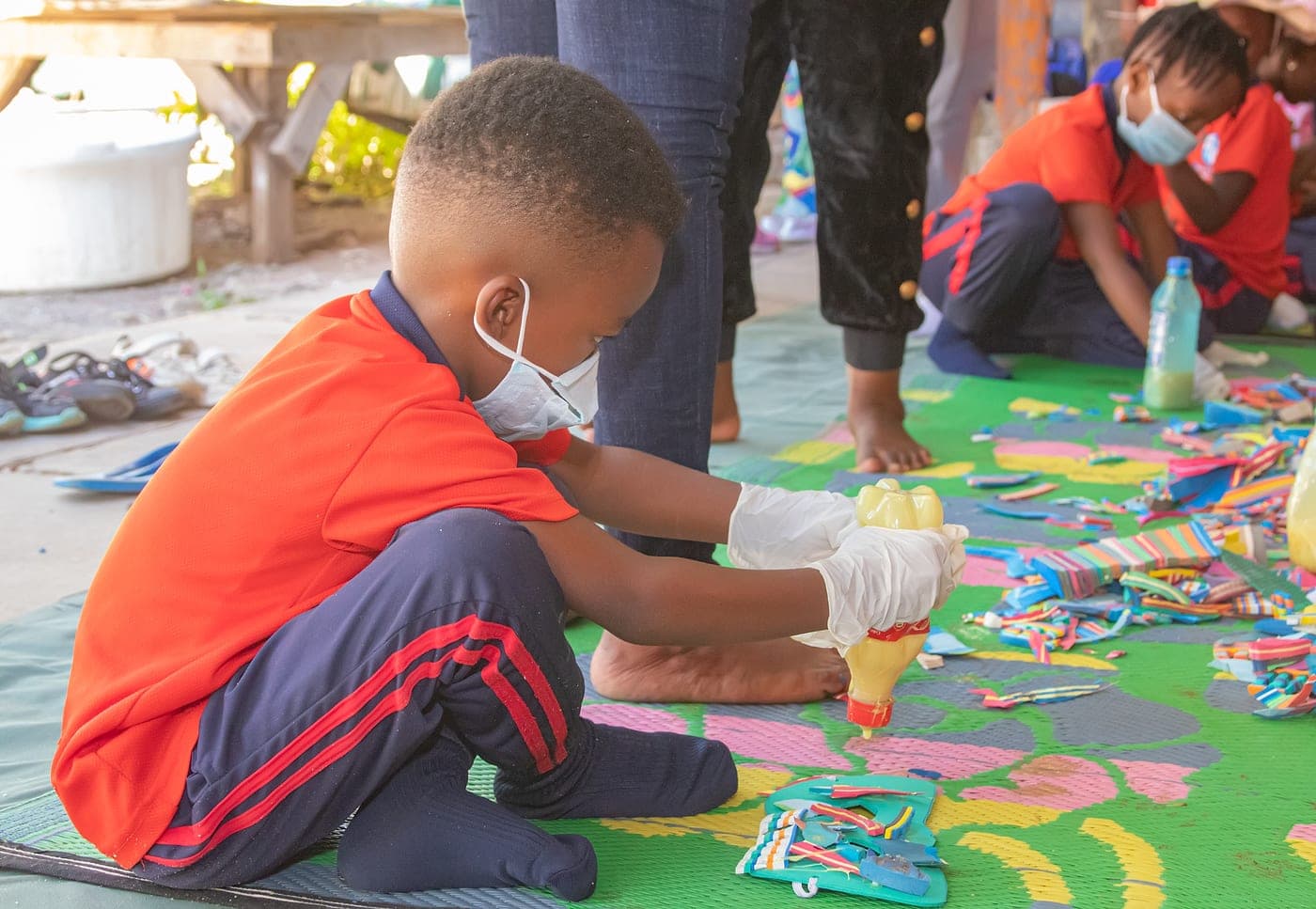 A child making a sculpture from upcycled materials
