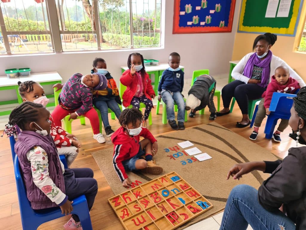 Young children learning with Montessori materials in a circle