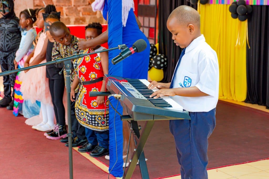 A learner playing keyboard at a school performance
